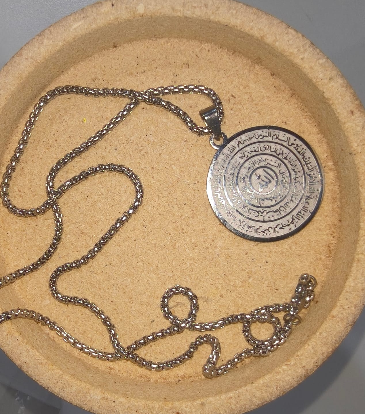 Customer photo review of HilalHaven Polished Round‑Disc with Circling Quranic‑Ayatul Kursi Verse Allah Necklace