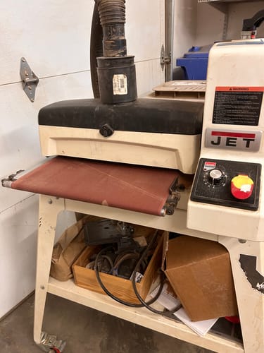 Customer's JET drum sander with the newly installed reddish-brown conveyor feed belt.