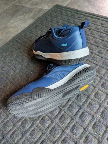 Customer's blue CUURT Muuv court shoes showing the rugged tread pattern and wide toe box.