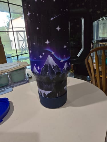 Customer's Nightfall Thicc Buddy tumbler with a mountain and star design, showing a protective base cover.