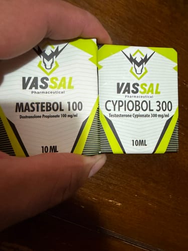 Customer's hand holding a Mastebol 100 box next to a Cypiobol 300 box, both featuring white and neon yellow branding.