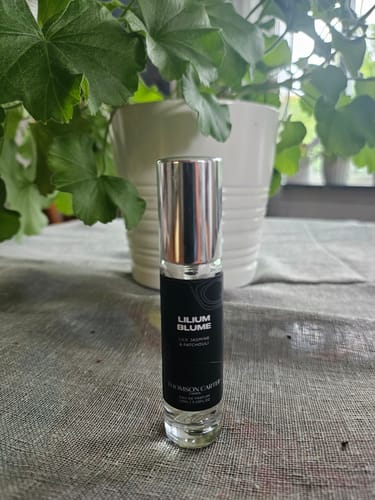 Customer's Lilium Blume perfume bottle on a table in front of a green potted plant