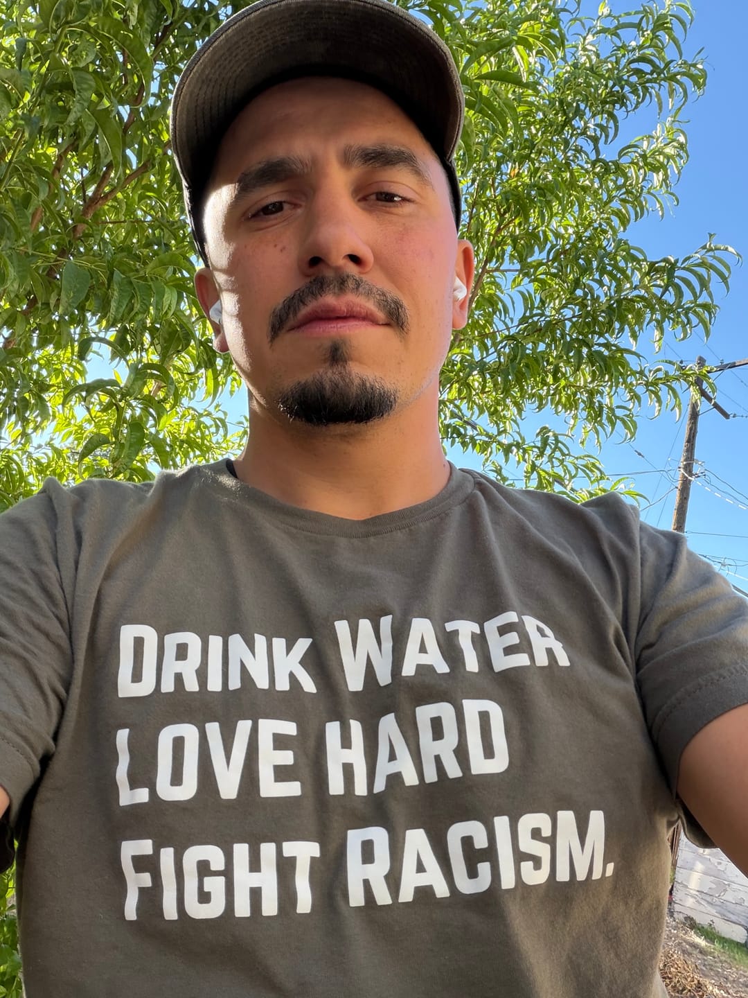 Customer photo review of Drink Water Fight Racism Unisex T-shirt