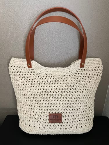 Customer's completed Sunny Beach Tote crochet kit, featuring a cream-colored mesh bag with brown leather handles.