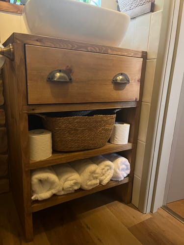 Customer's Rustic Wood Bathroom Vanity Unit with a white basin and rolled white towels on open shelves.
