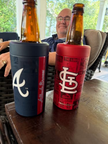 Customer's Universal Buddy can coolers, one Atlanta Braves and one Cardinals themed, holding bottles on a wooden table.