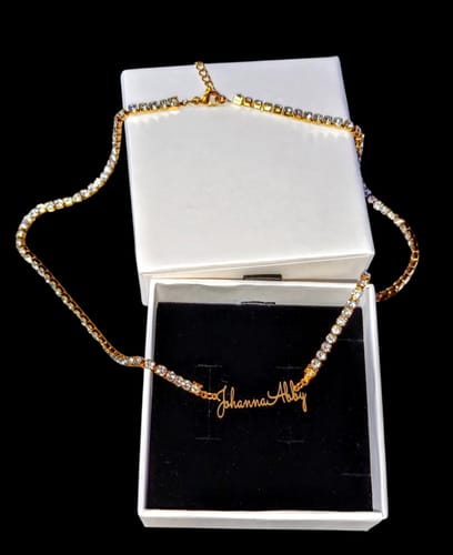 Customer's gold Signature Name Tennis Necklace showing the script name Johanna Abby in an open white gift box