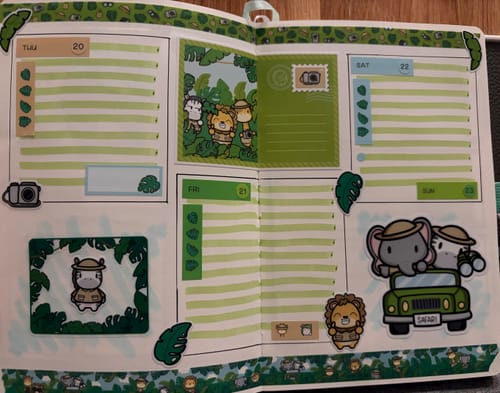 Customer's journal spread featuring Ultimate Subscription safari stickers, animal characters, and green washi tape.