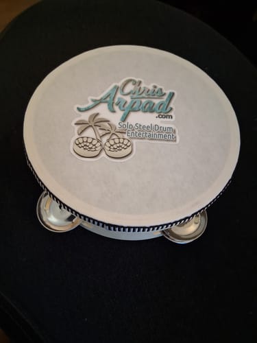 Customer's custom vinyl sticker applied to the white drum head of a tambourine.