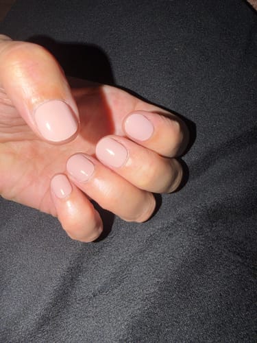 Customer's hand showing neatly applied light pink UV Gel Nail Wraps