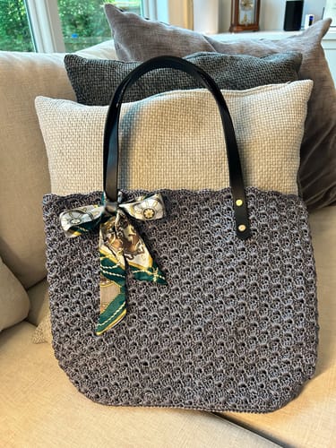 Customer's completed Aveline crochet Shoulder Bag with dark leather straps and an attached patterned scarf.