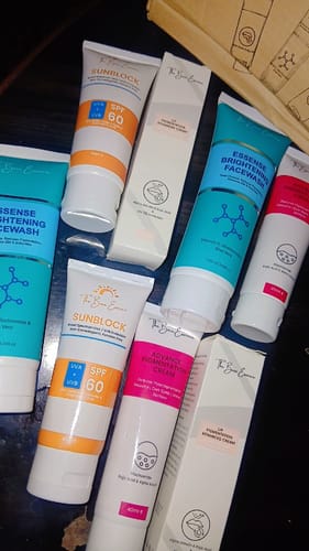 Customer's All Glow Pigmentation Bundle skincare set, featuring multiple tubes and boxes on a dark surface.
