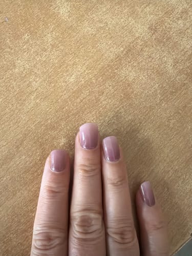 Customer's hand showing UV Gel Evening Out Ombré nail wraps with a smooth pink gradient finish.