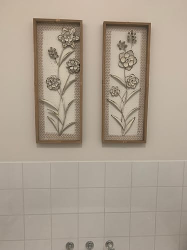 Customer's Aurélien botanical wall art set of two framed metal floral panels mounted side by side on a tiled wall.