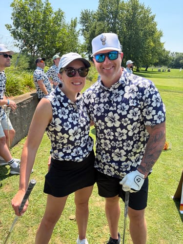 Customer's Men's Summer Daisy golf polo worn by a person on a golf course