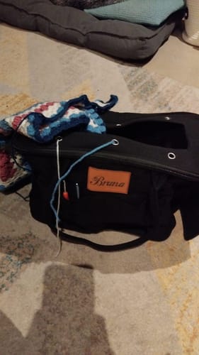 Customer's black Personalized Monogram Yarn Storage Bag with a custom name tag, featuring knitting tools and yarn.