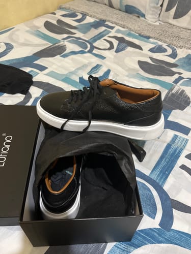Customer's Lufiano Lace up shoes in black leather, sitting in an open box on a patterned bedspread.
