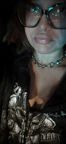 Reviewer wearing a silver-toned Astrology Choker with a clear clasp detail around their neck