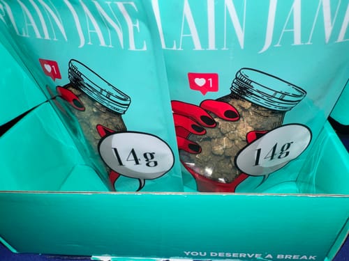 Customer's Black Cherry Gelato THCA Flower packaging inside a teal box, displaying two fourteen-gram pouches.