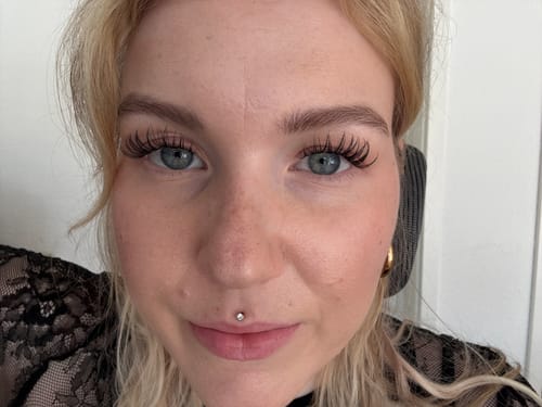 Reviewer's eyes with applied Pink Wink lash extensions in a natural cateye style.