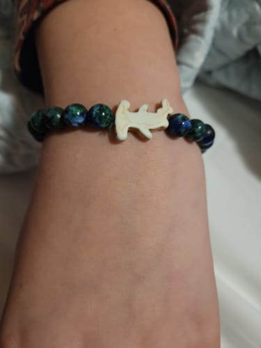 Customer's Shark Week Bracelet with dark blue beads and a white hammerhead charm worn on a wrist
