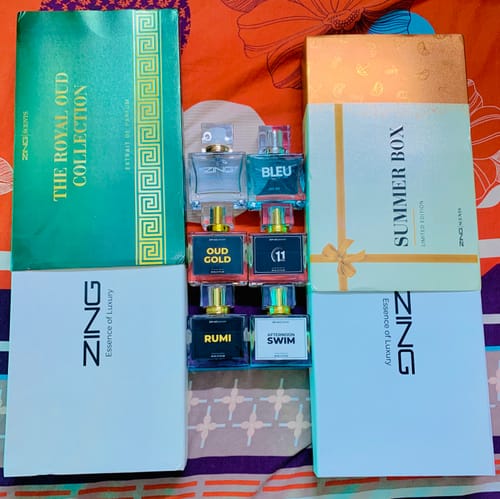 Customer's OUD Supreme Bundle including The Royal Oud Collection green box and several glass perfume bottles.