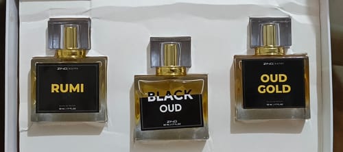 Customer's Royal Oud Collection gift box containing three rectangular perfume bottles labeled Rumi, Black Oud, and Oud Gold.