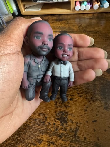 Customer's Dodowish custom figurine of two people held in a hand