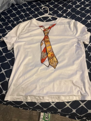 Customer's white Skinny Printed Round-Neck T-Shirt with a printed necktie design hanging on a hanger.