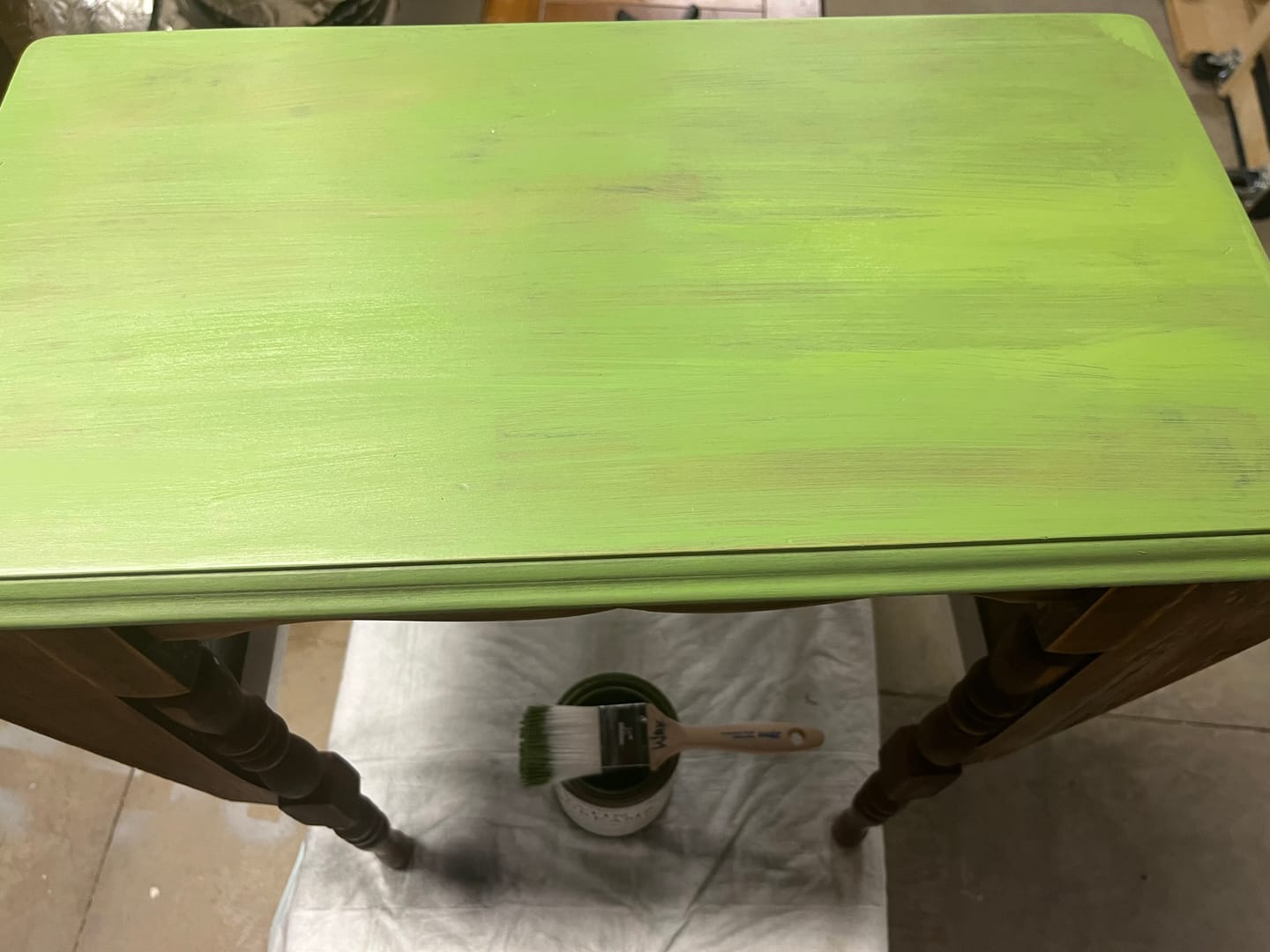 Dark stained vintage tabletop after one coat of Satin Dreams with no primer, the stain still showing through