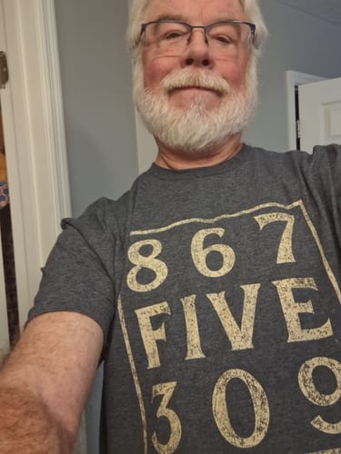 Customer wearing the grey 8675309 T-Shirt with large distressed white text