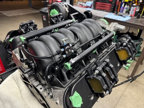 Customer's Motion Raceworks V2 LS Flex Line Coolant Crossover Steam Kit installed on a black engine intake.