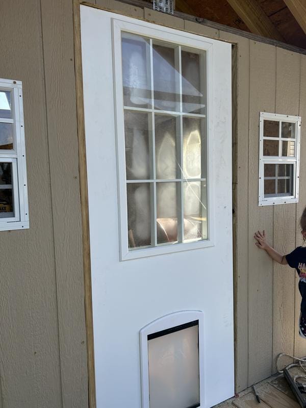Customer photo review of TENONER White Primed 9-Lite Clear Glass Exterior Door with Pet Door, No Hinges or Handles Included
