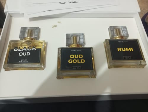 Customer's Royal Oud Collection set with three perfume bottles labeled Black Oud, Oud Gold, and Rumi in a white box.