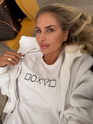 Customer's white Pohuy Tee shirt worn by a person, showing the black graphic logo on the chest.