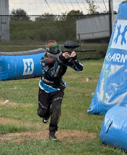 Customer's Custom Jersey, blue and black, worn while playing paintball on a field.