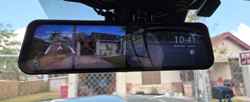 Customer's Universal Bracket for Mirror Dash Camera mounted on a rearview mirror showing a dual-view display screen.