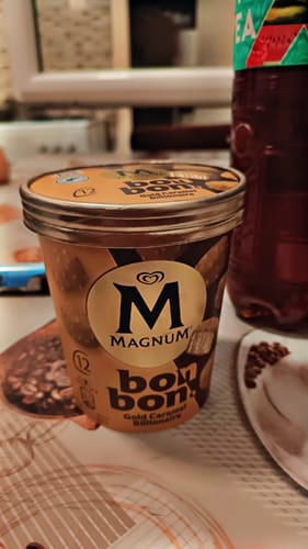 Customer's container of Magnum Bon Bon Gold Caramel Billionaire ice cream sitting on a patterned surface