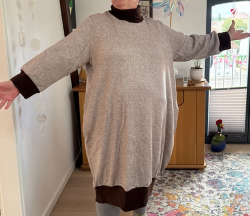 Customer's beige and brown colorblock turtleneck dress, worn to show the fit and comfortable sleeve length.