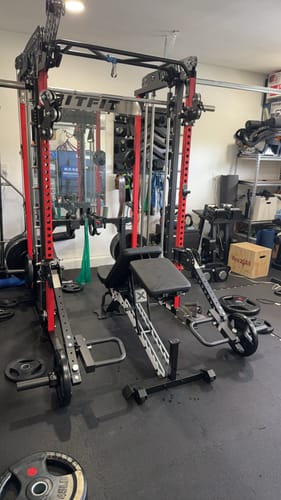 Customer's RitFit LAM1 adjustable lever arm attachment mounted on a black and red home gym rack