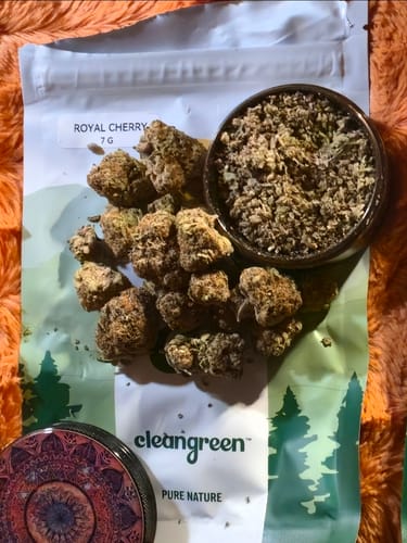 Customer's Royal Cherry flower buds and ground product, sitting on branded Clean Green packaging.