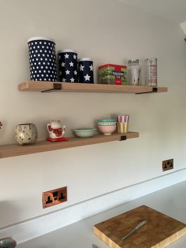 Customer's Oak Shelves with Inverted Brackets installed on a wall, holding various kitchen items.