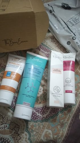 Customer's All Glow Pigmentation Bundle items including a sunblock, facewash, and two cream tubes on a patterned surface.