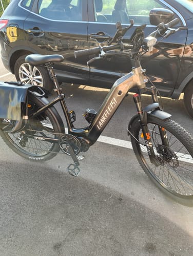 Customer's Lankeleisi MG600 Lite e-bike parked on asphalt next to a black car, featuring a rear bag.