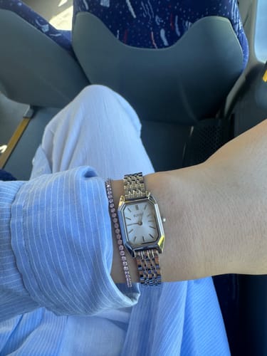 Customer's Ava Petite Silver Pink Bracelet paired with a silver-toned watch, worn on the wrist while seated.