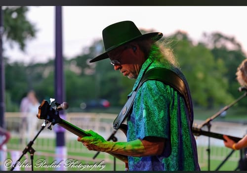 Customer's Big Wide Brim Felt Hat being worn by a musician performing outdoors at twilight.