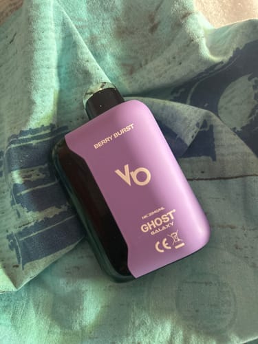 Customer's purple Ghost Galaxy 25000 Puffs Disposable Vape Bar, Berry Burst flavor, resting on a textured fabric.