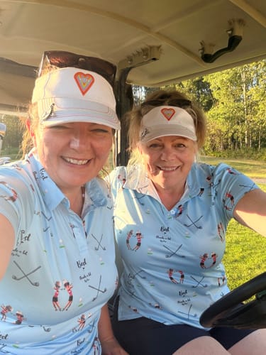 Customer's Custom Couple Photo Face & Name Women's Golf Polo worn by two smiling people in a golf cart.
