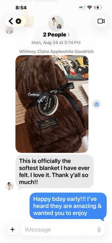 Customer's brown Hugs Hot Fudge Blanket wrapped in a branded ribbon shown in a text message conversation.