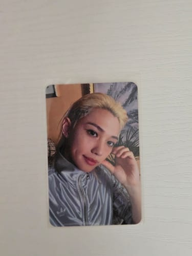 Customer's Stray Kids Music Plant photocard, showing a blonde person wearing a silver jacket